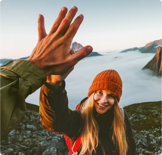 Smiling woman high-fiving her travel partner
