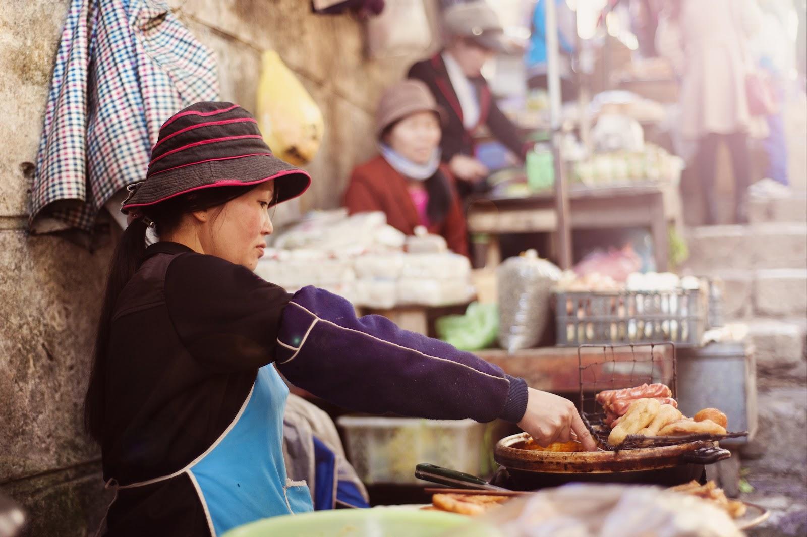 A street food seller cooking on a bbq in Vietnam.