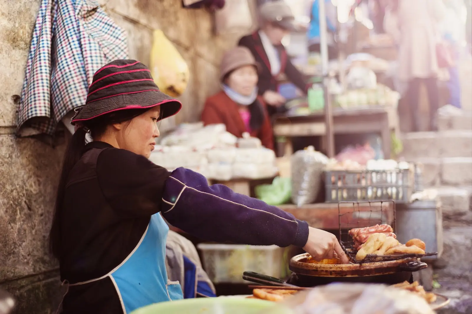 A street food seller cooking on a bbq in Vietnam.