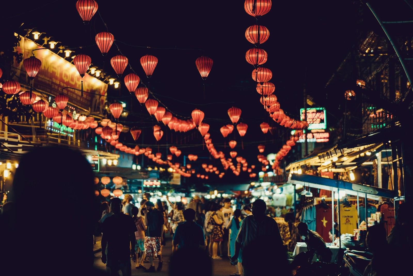 A busy night market full of lanterns in Vietnam. 