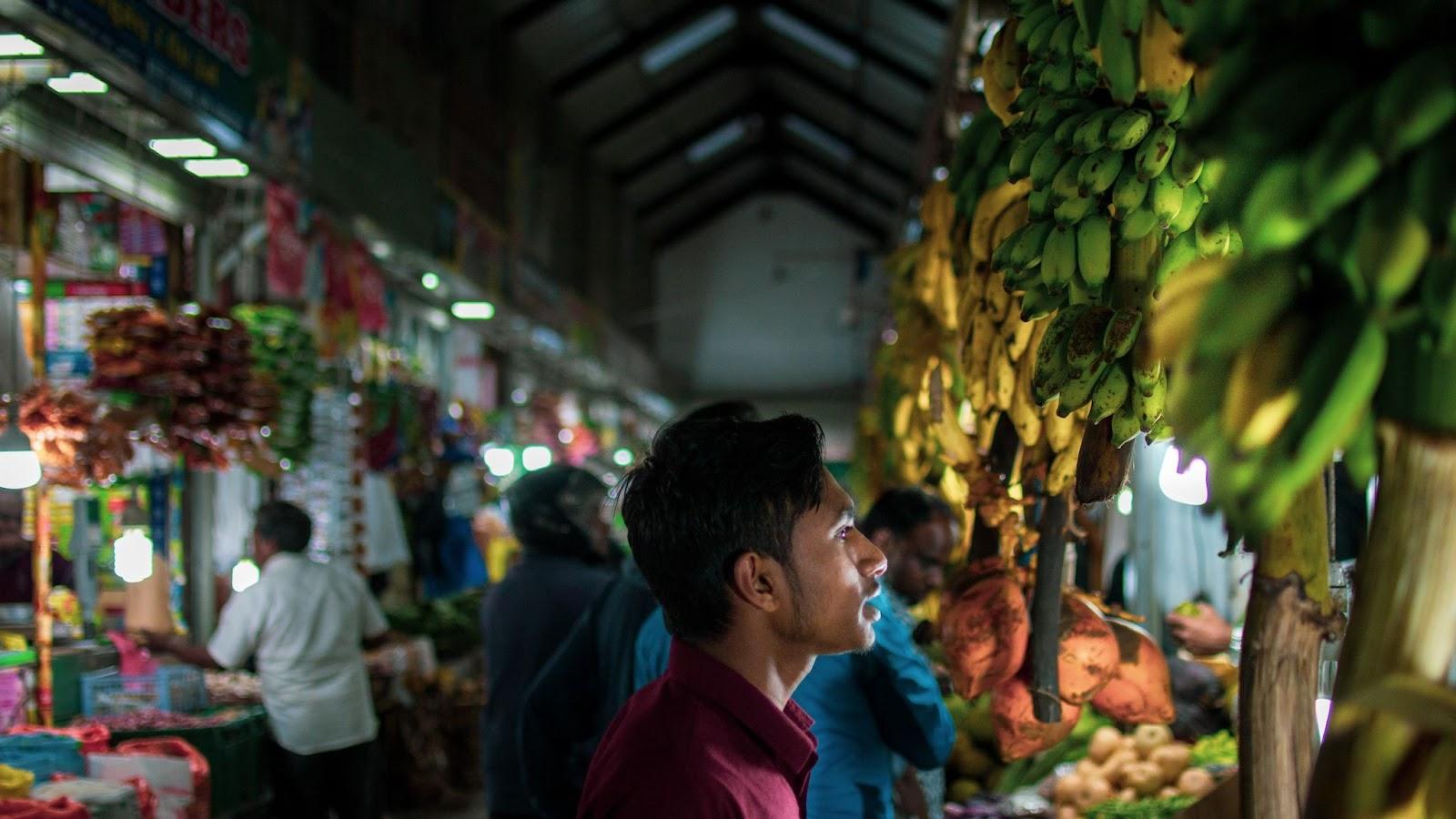 A local buying fruit at a local market in Sri Lanka