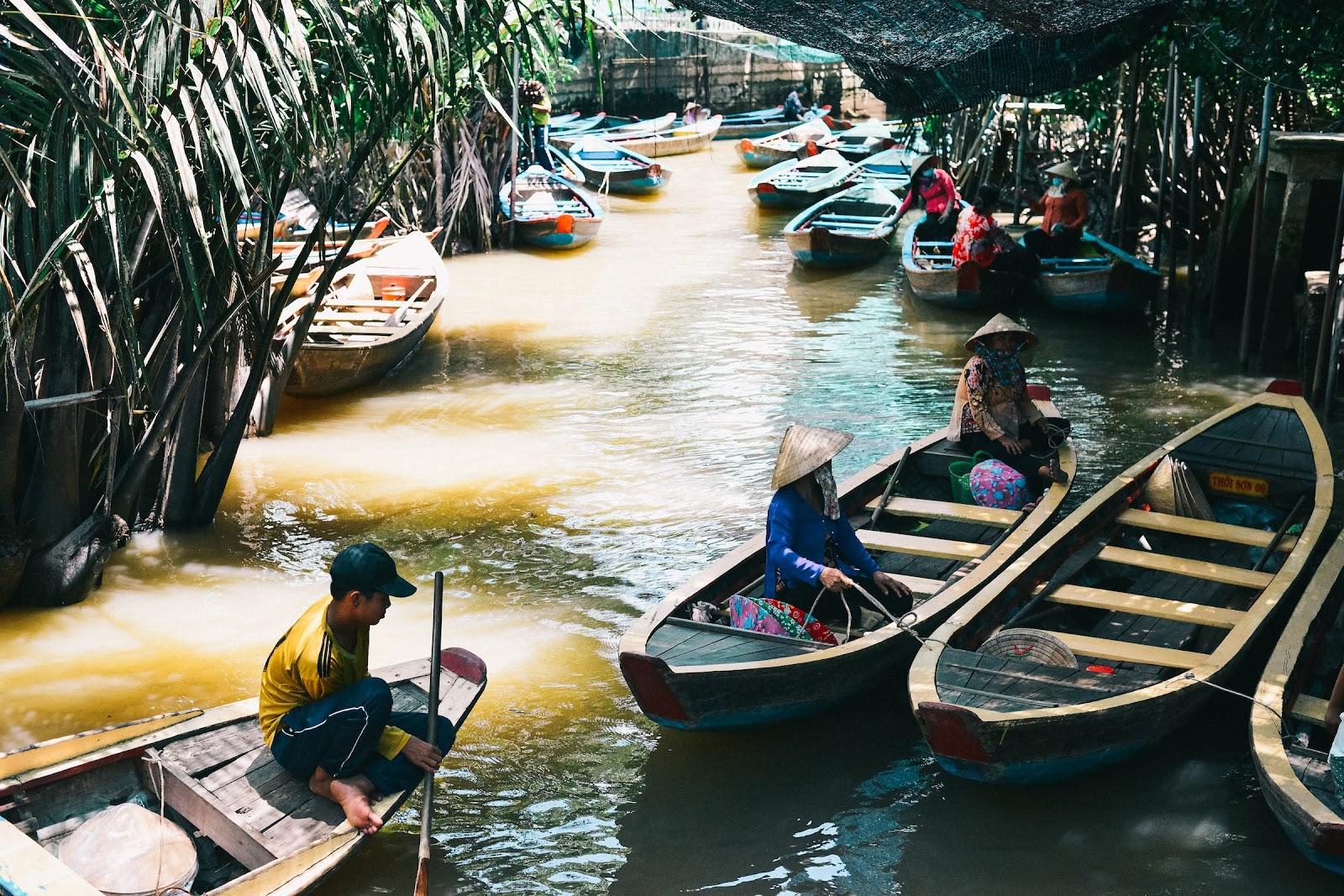 A narrow river with paddle boats in Vietnam,