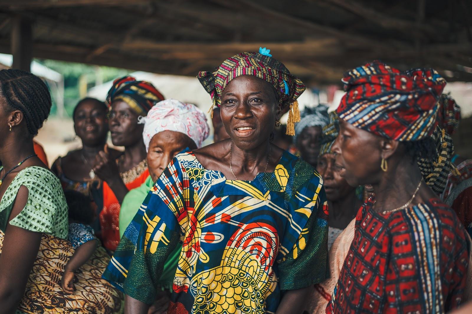 A group of Ugandan women wearing traditional clothing and accessories.
