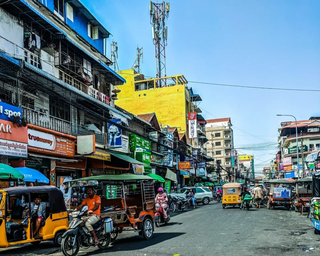 Bustling multicoloured street scene with tuk tuks