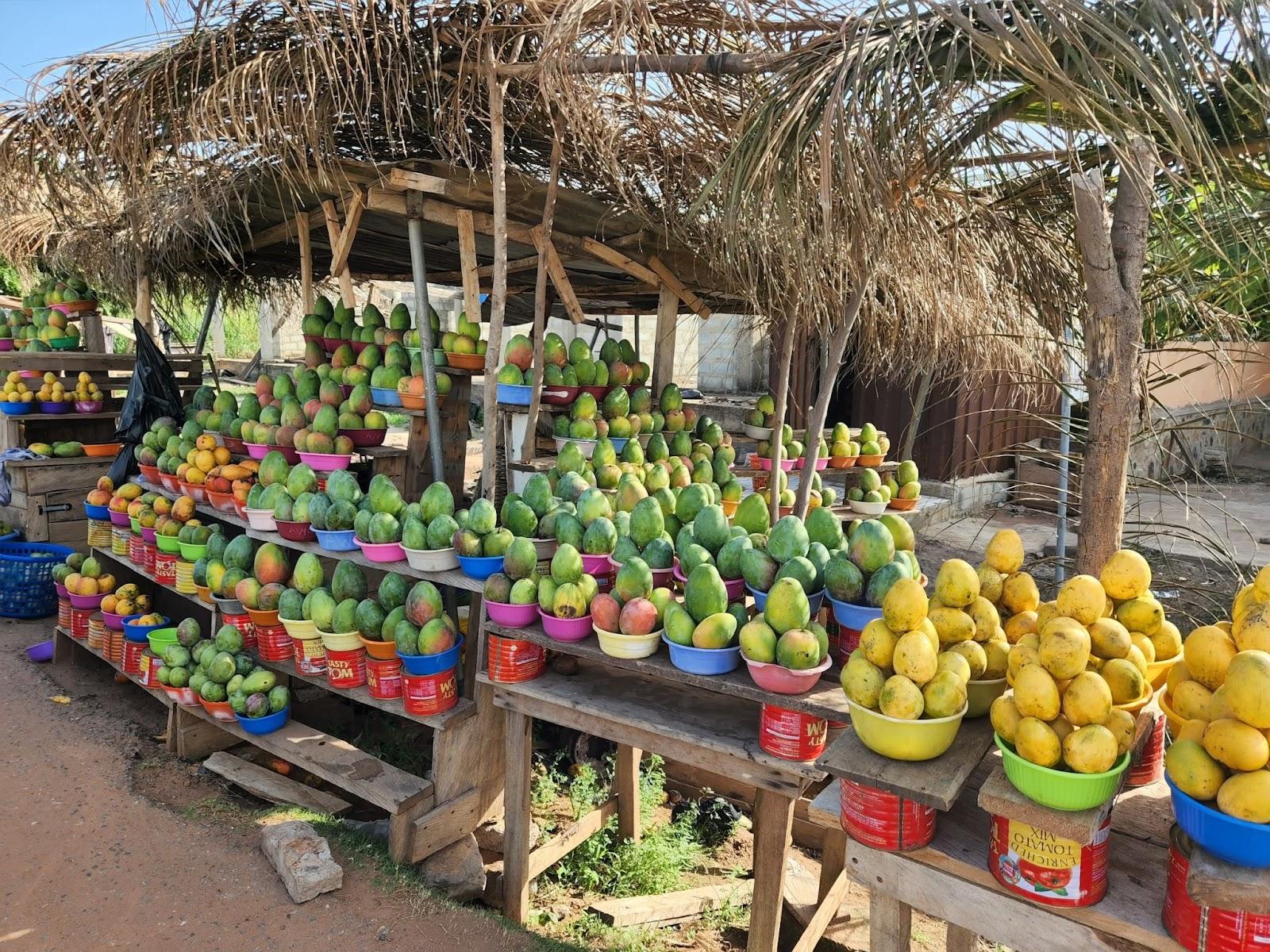 Roadside market in Ghana stalls selling ripe mangoes