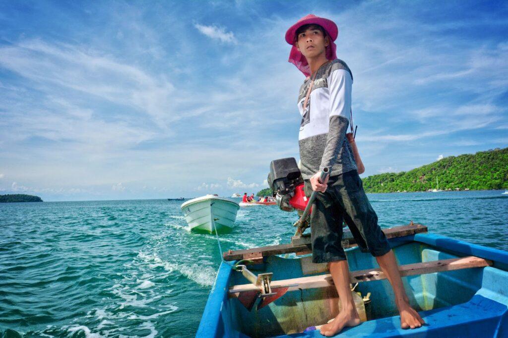 A man in a fishing boat in Cambodia.