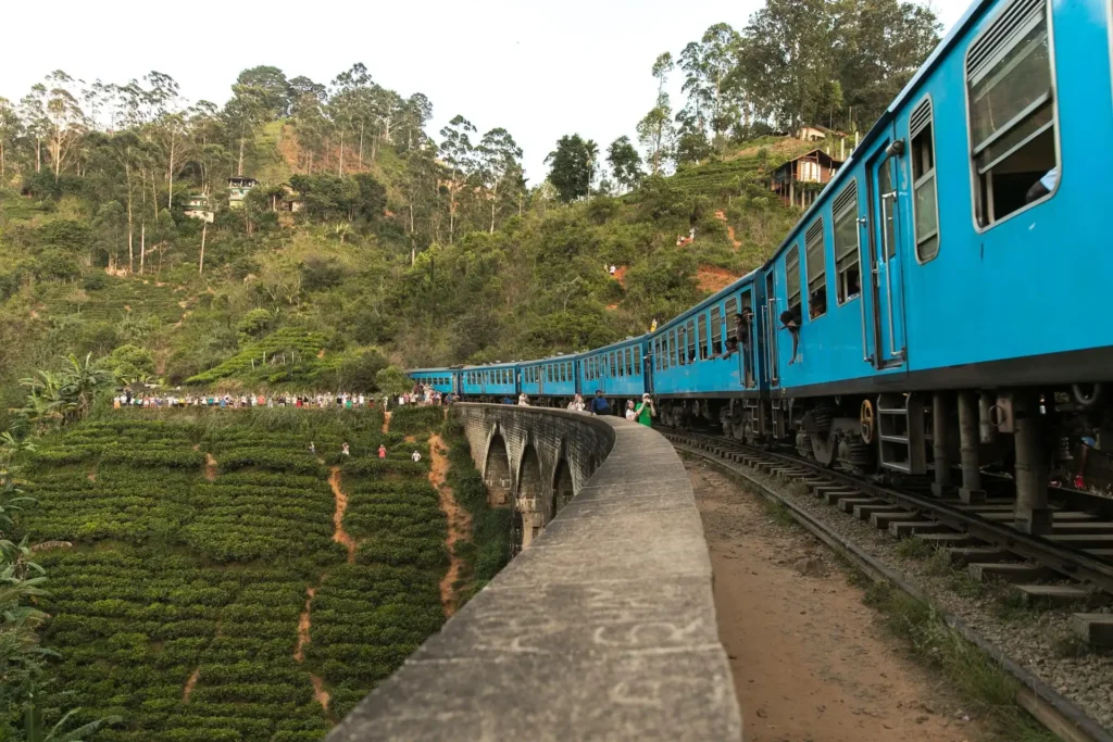 Sri Lanka railway line with mountains and forests in the background.