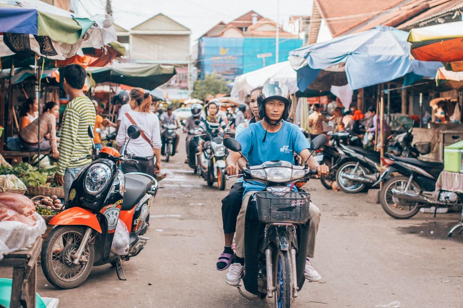 A man riding a motorbike in Cambodia