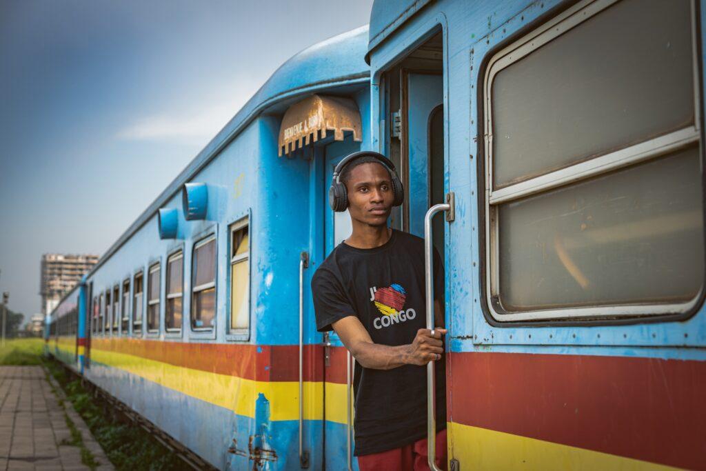 Colourfully painted train carriage with passenger in the Congo