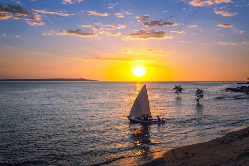 Mahajanga beach, Madagascar at sunset with a small boat just off the beach