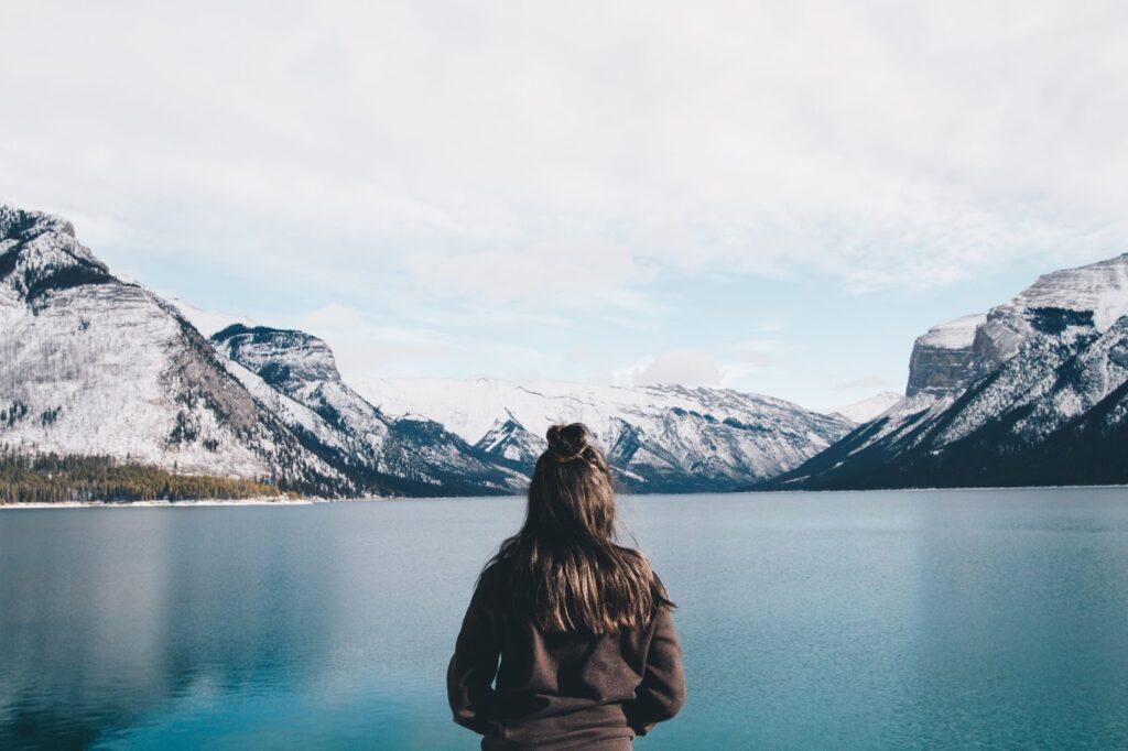 Tourist looking out over Lake Minnewanka, Canada
