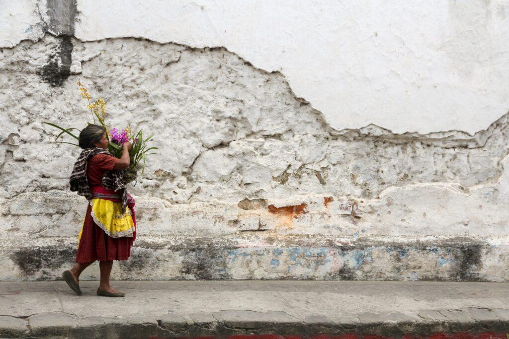 Lady wearing traditional clothes walking in Antigua Guatemala