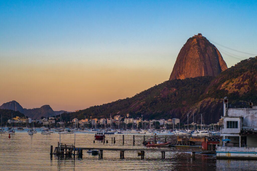 the pier with boats docked in front of Sugarloaf Mountain