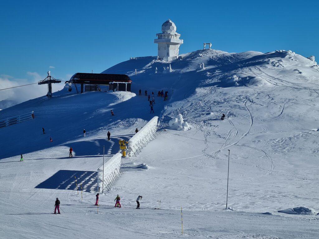 Jahorina Ski Resort, featuring people skiing down the slops.