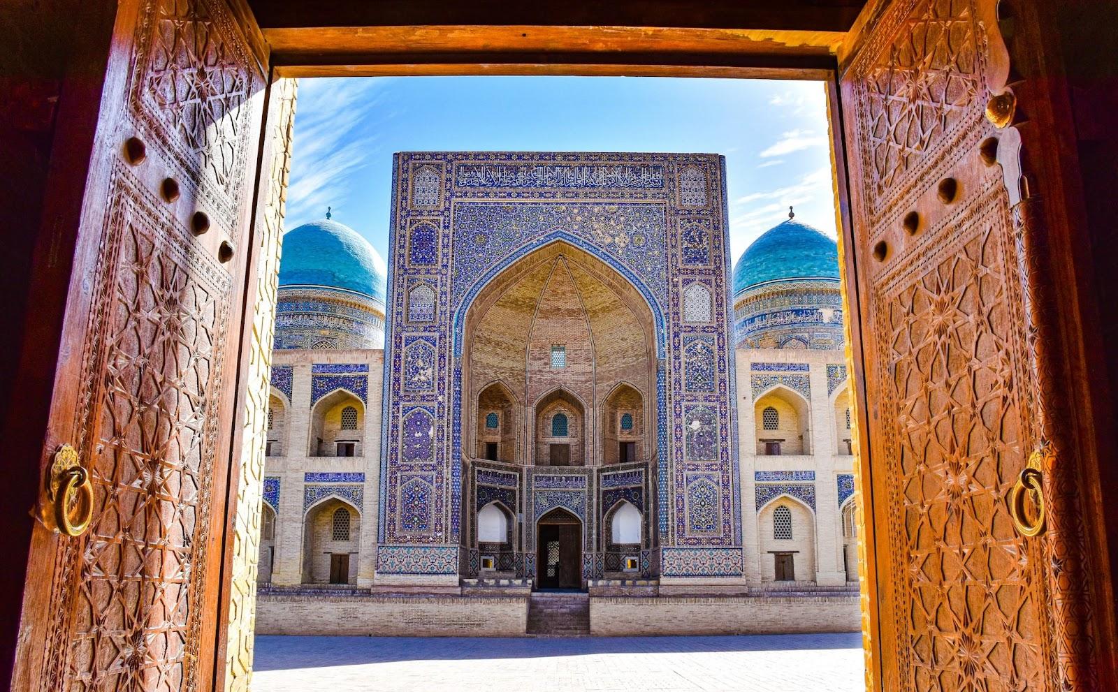 The Mir-i-Arab Madrasa building, featuring intricate patterns and architecture.