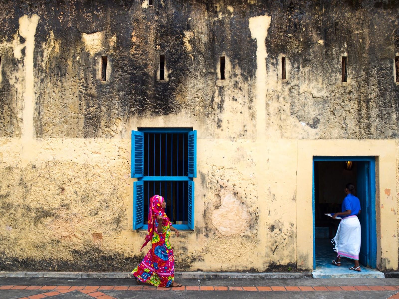 Two Tanzanian women walking into a building in Tanzania