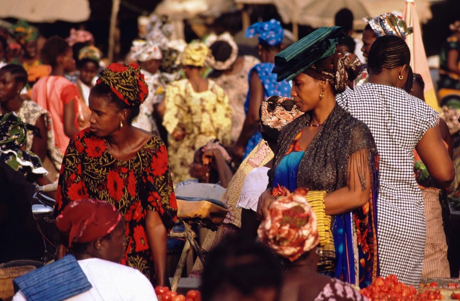 West African women in brughly coloured traditional dress