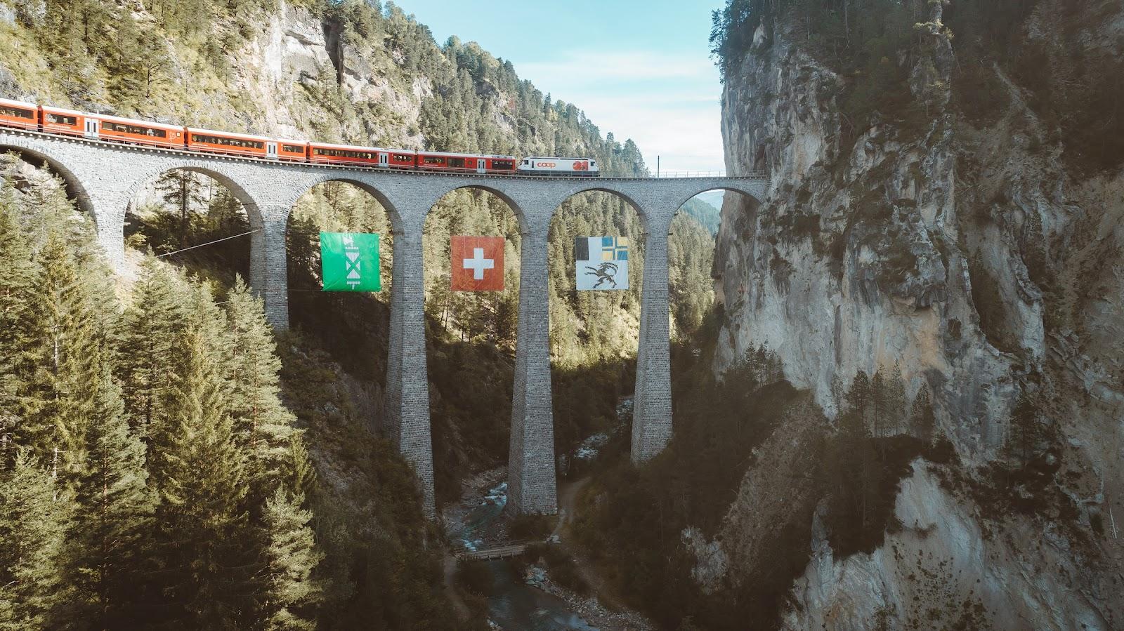 A train crosses a bridge in the swill alps.