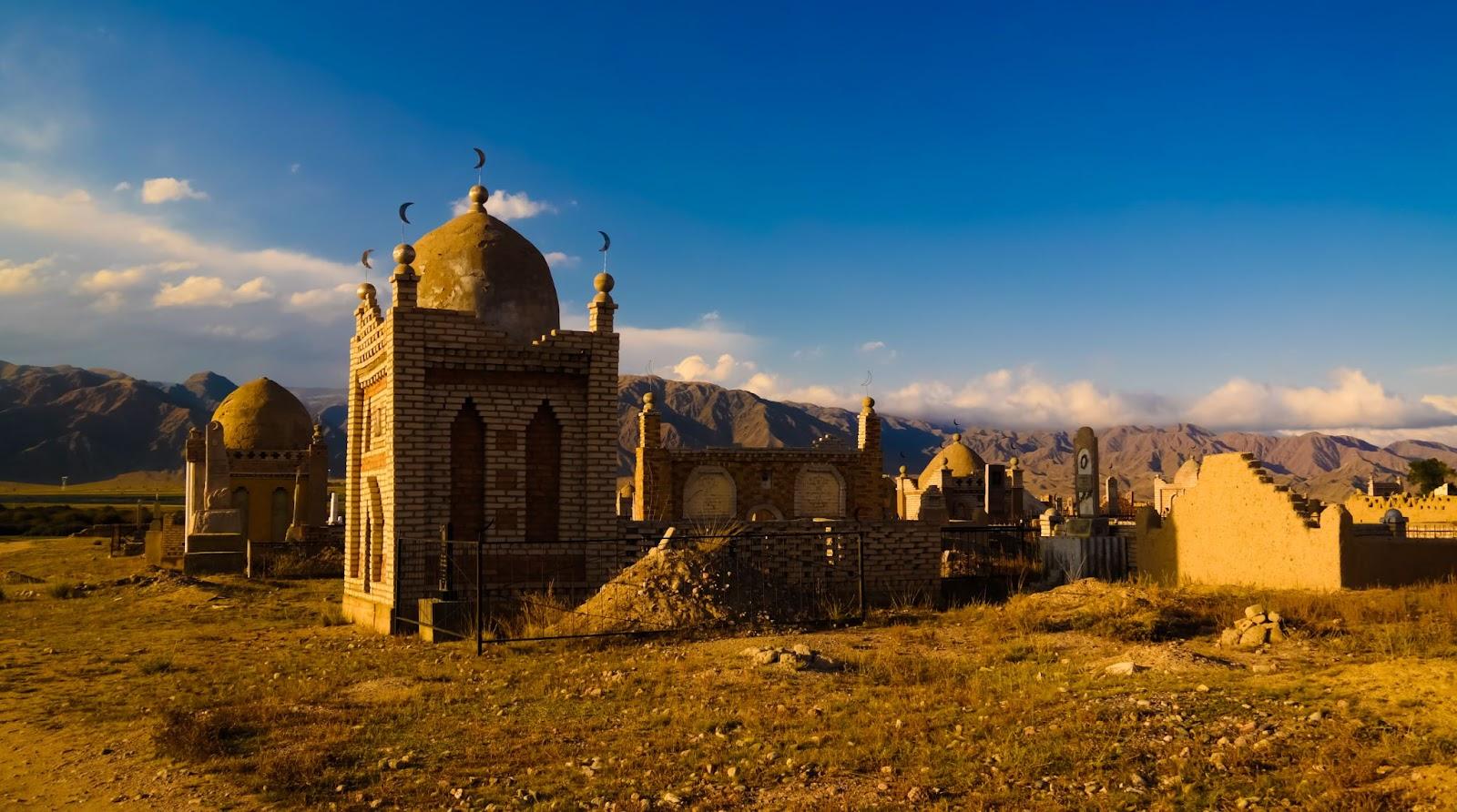 Panorama view to muslim cemetery Semiz Bel at sunset at Kochkor in Naryn region, Kyrgyzstan