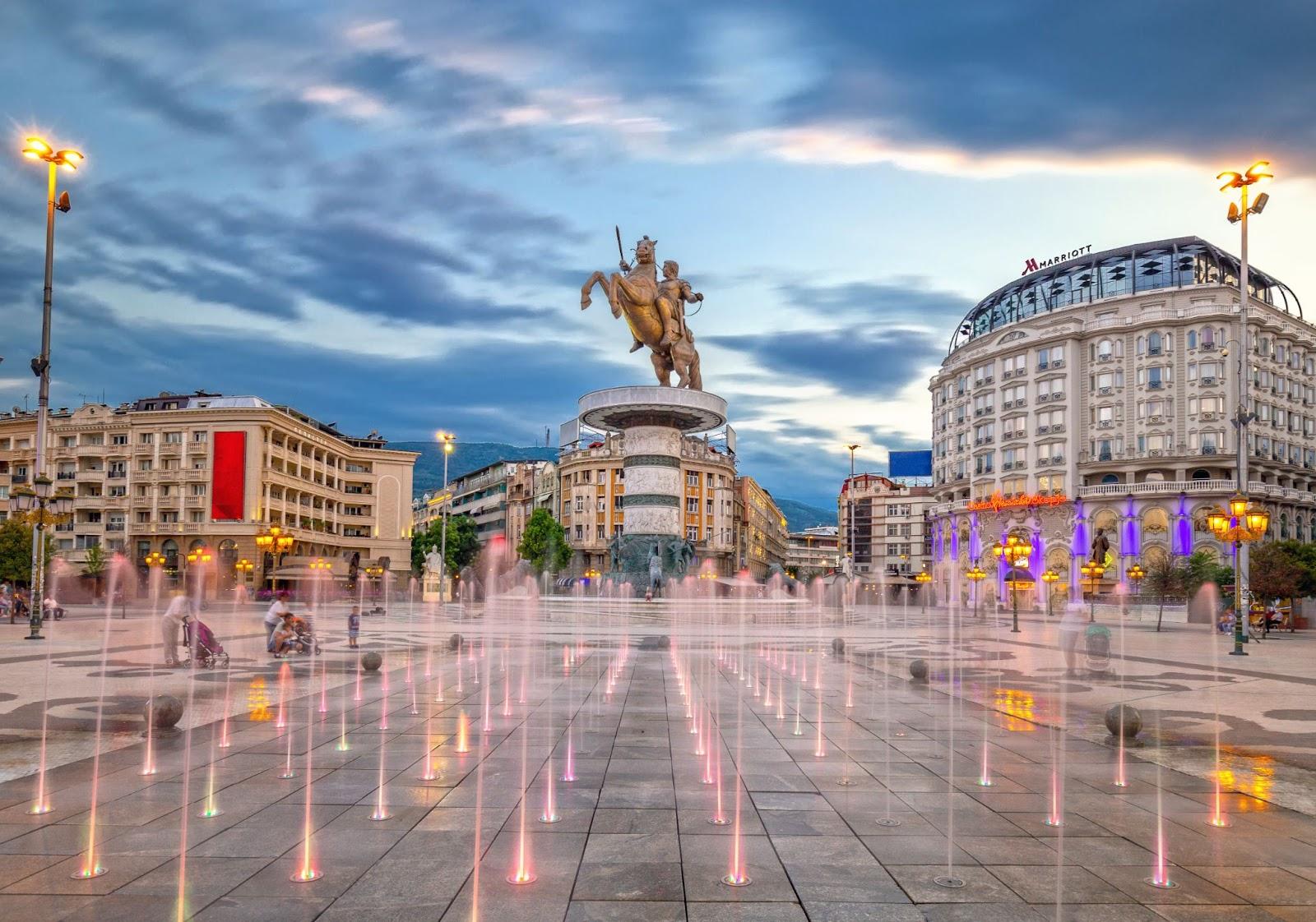 Skopje, North Macedonia - City square in Skopje at sunset with dancing illuminated fountains 