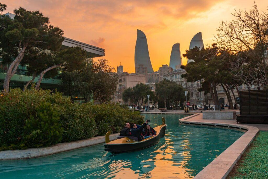 Azerbaijan, Baku. People boating on water channels.