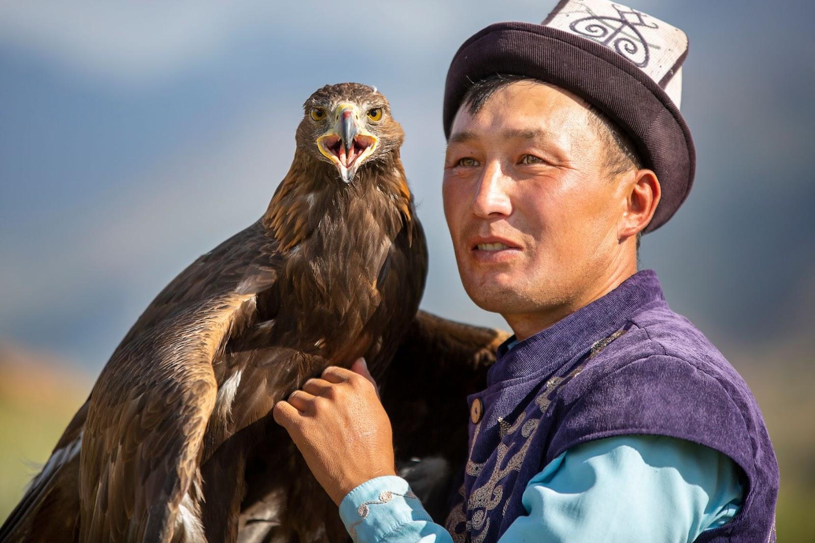 Eagle hunter and his Golden Eagle in Issyk Kul, Kyrgyzstan