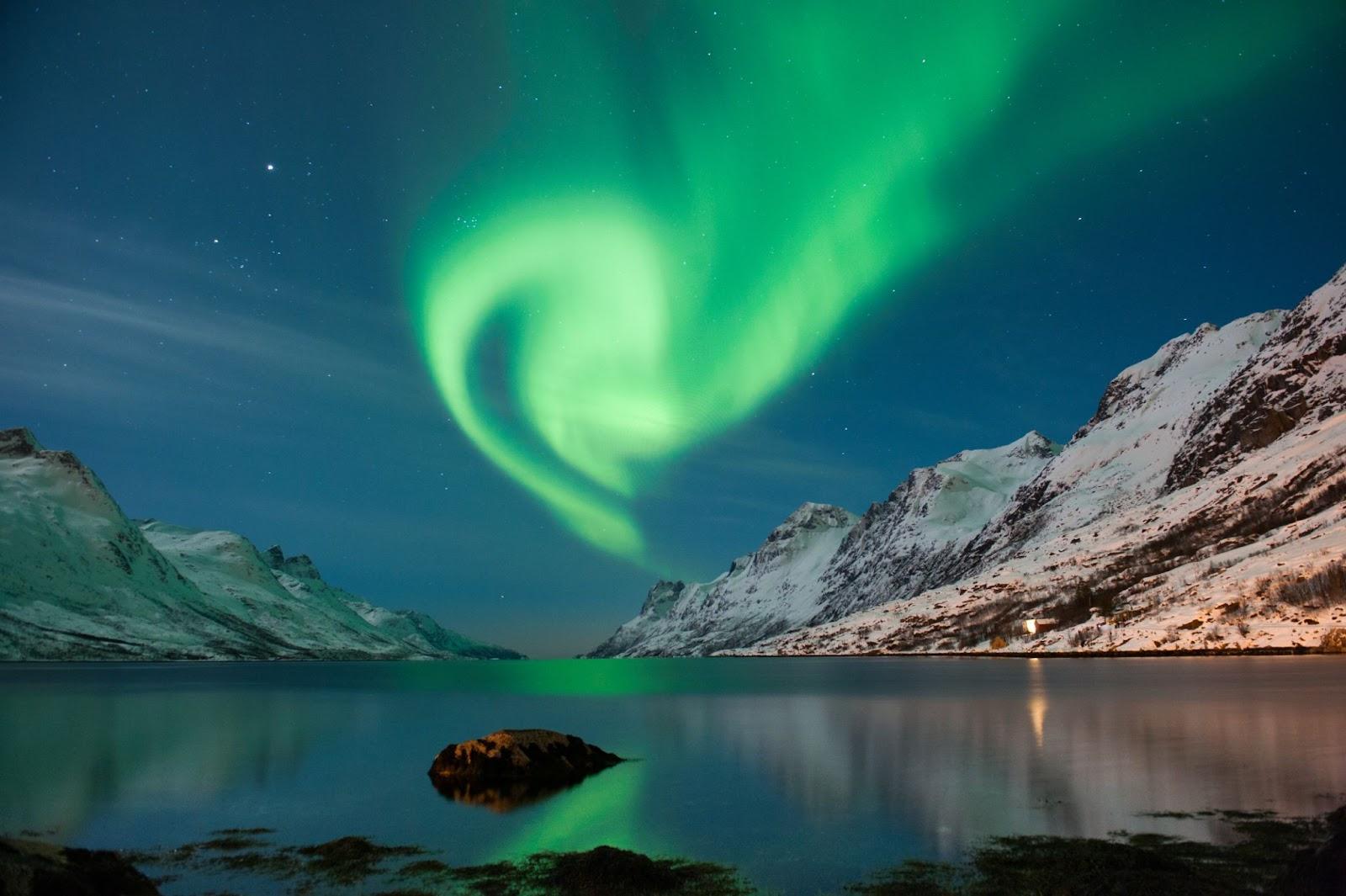 The northern lights over looking a lake in Norway. 