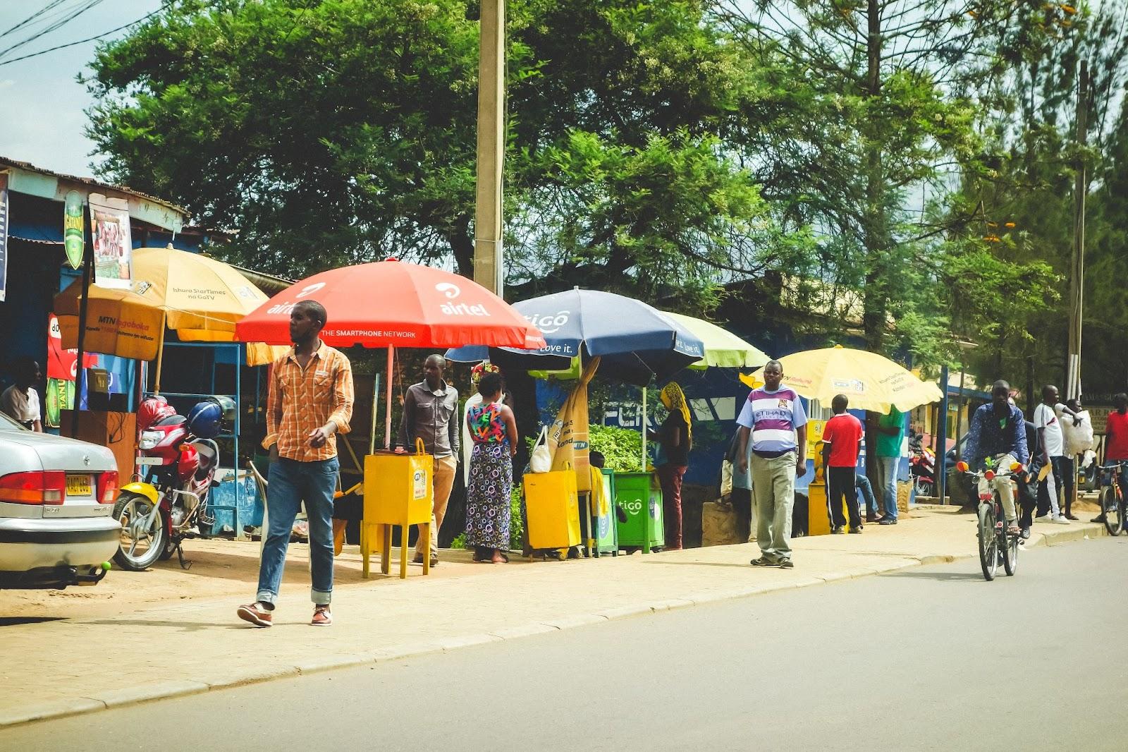 colourful streetscape with motos, bikes and people in the outskirts of the capital city, Kigali - Rwanda