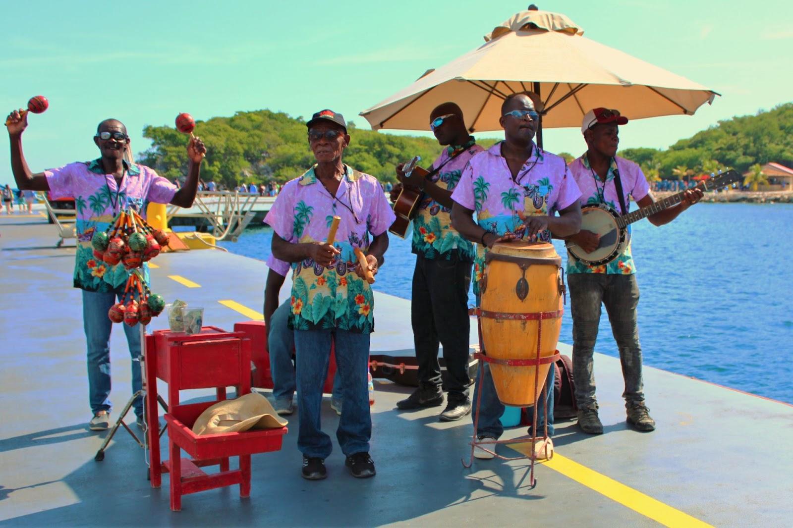 Local musicians play traditional music to greet the passengers arriving off of a cruise ship in Haiti