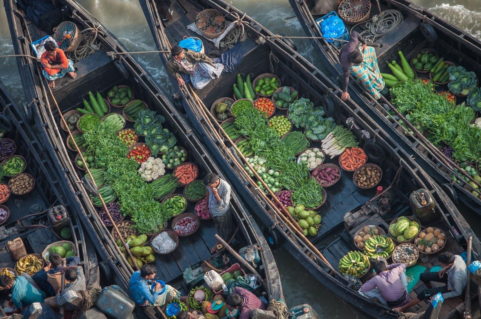 Bangladesh people sell goods from boat. Traditional floating bazaar.
