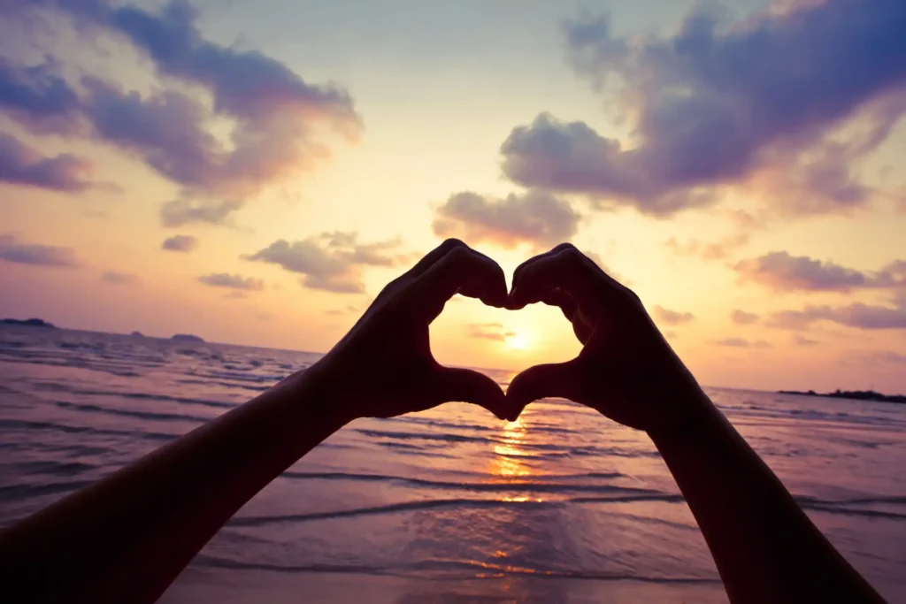 A couple using their hands to make a heart symbol for valentines day