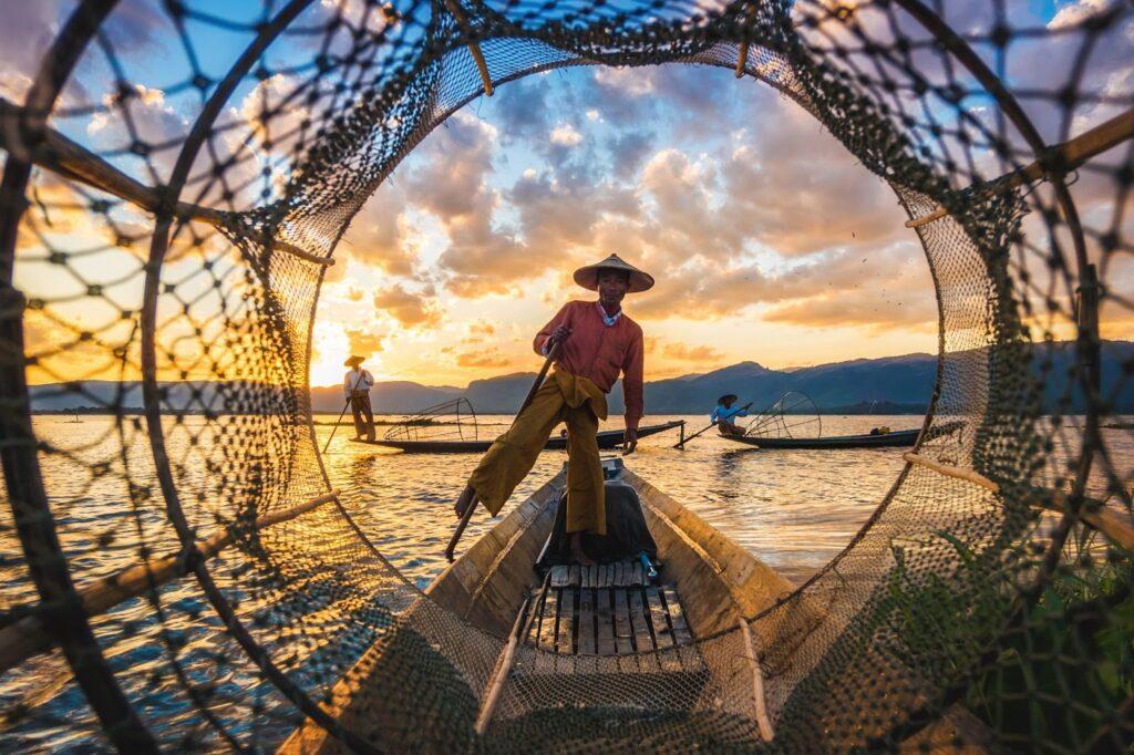 Inle Lake Intha fishermen at sunset in Myanmar.