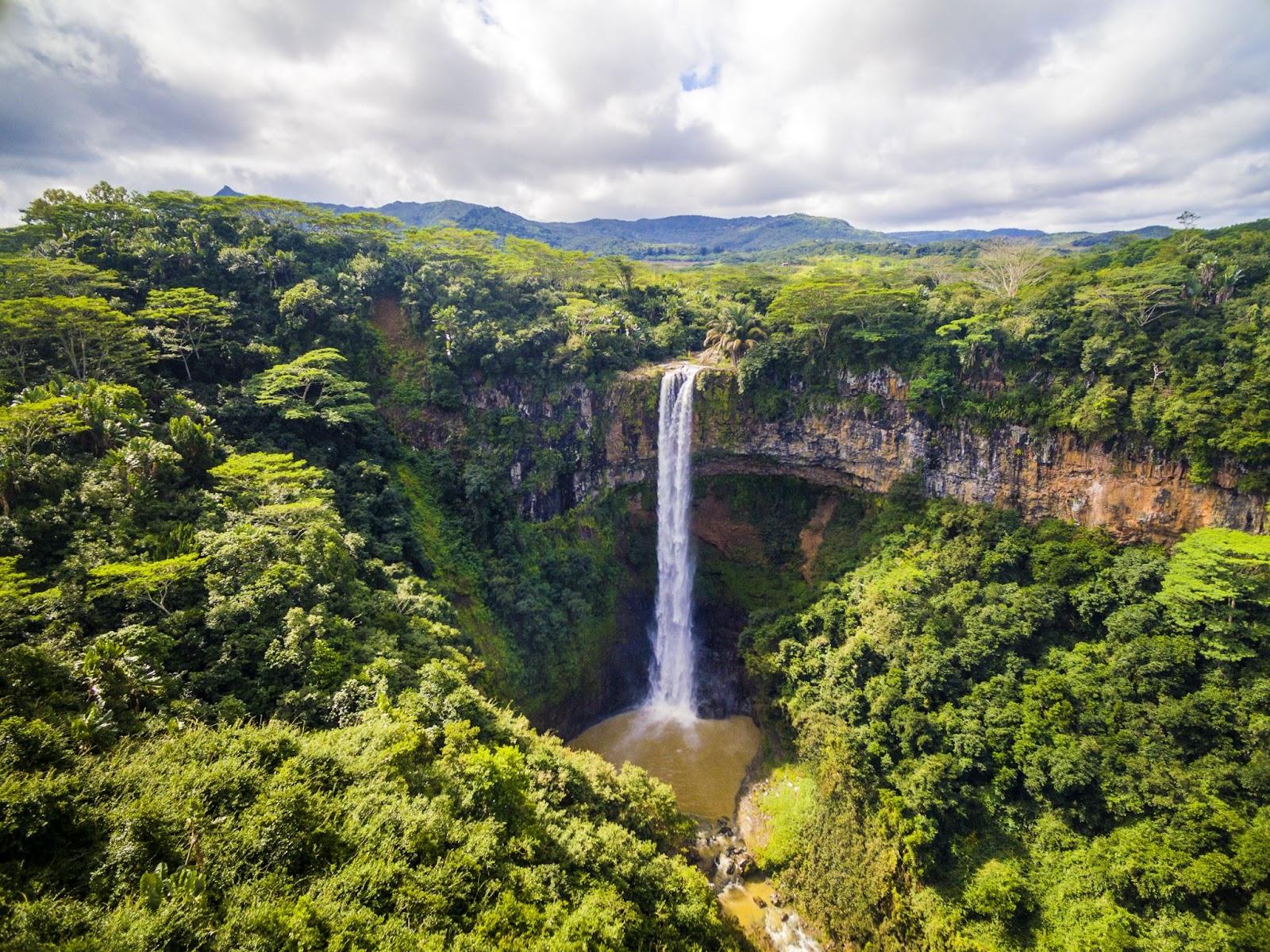 Aerial top view perspective of Chamarel Waterfall in the tropical island jungle of Mauritius