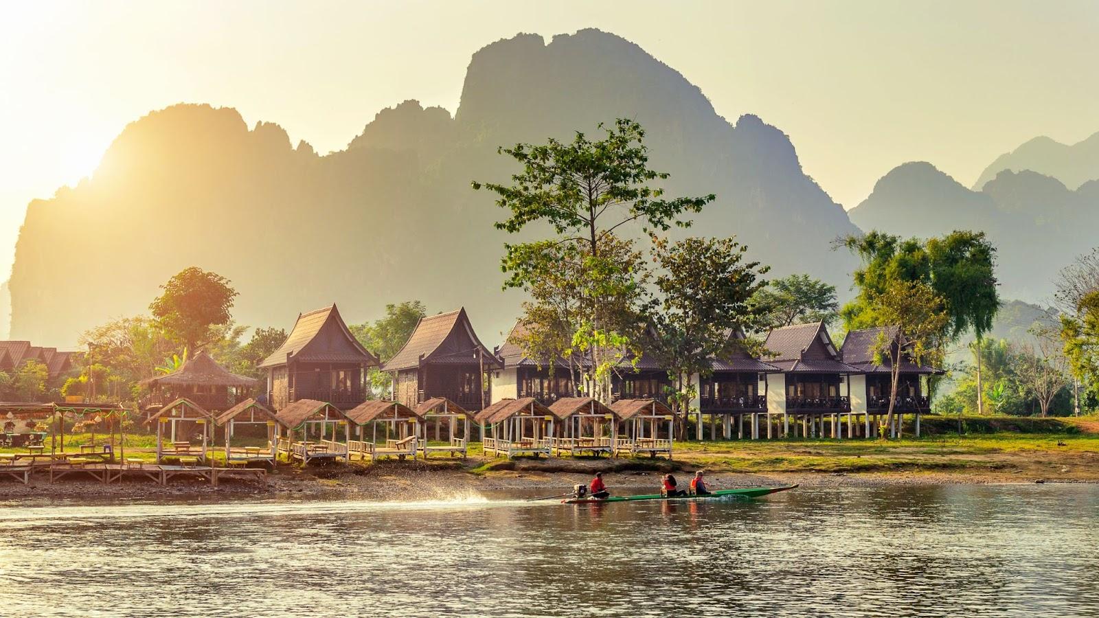 Village and bungalows along Nam Song River in Vang Vieng, Laos.