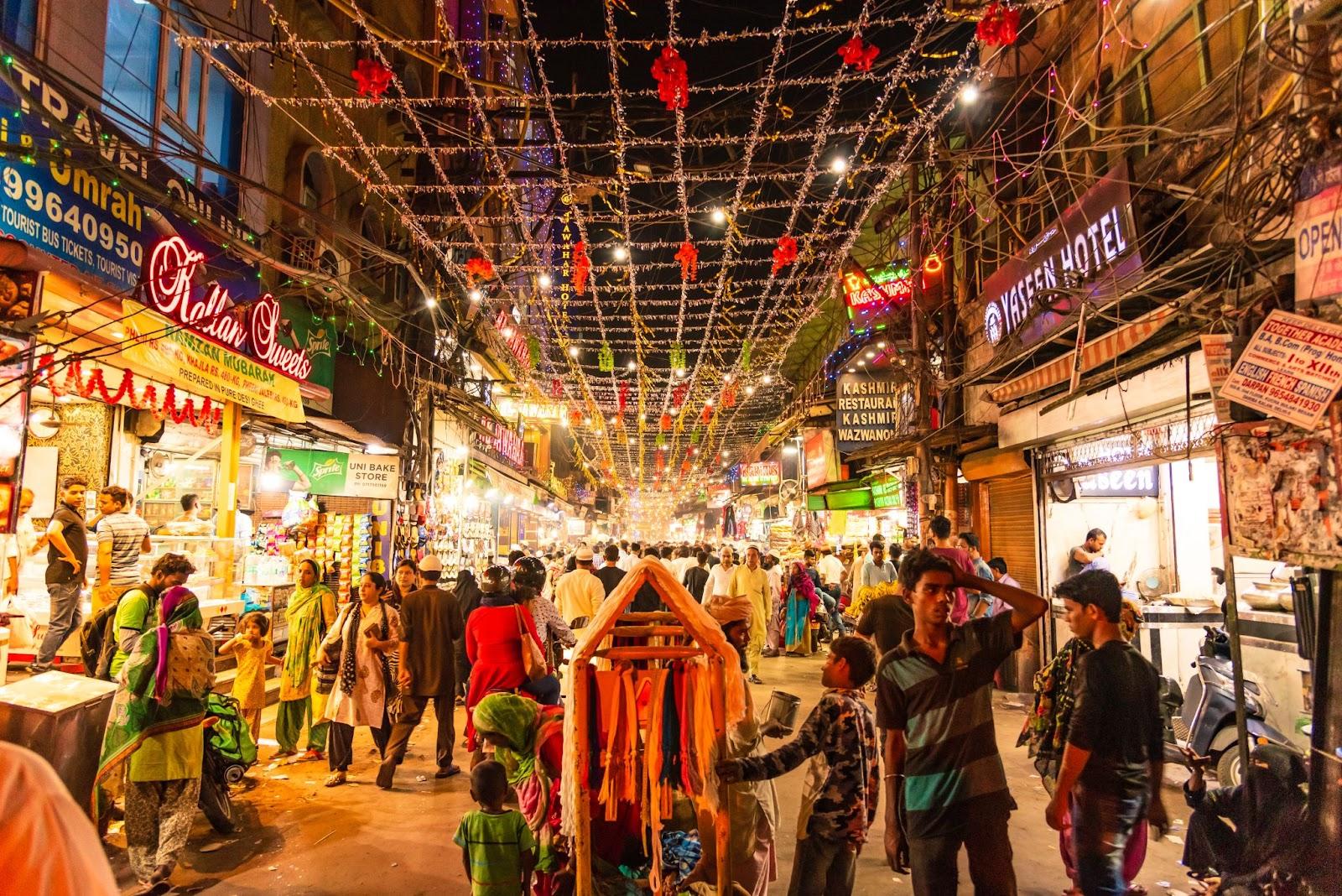 People in Urdu Bazar or market street of historical part of Chandni Chowk locality of Old Delhi in the evening.