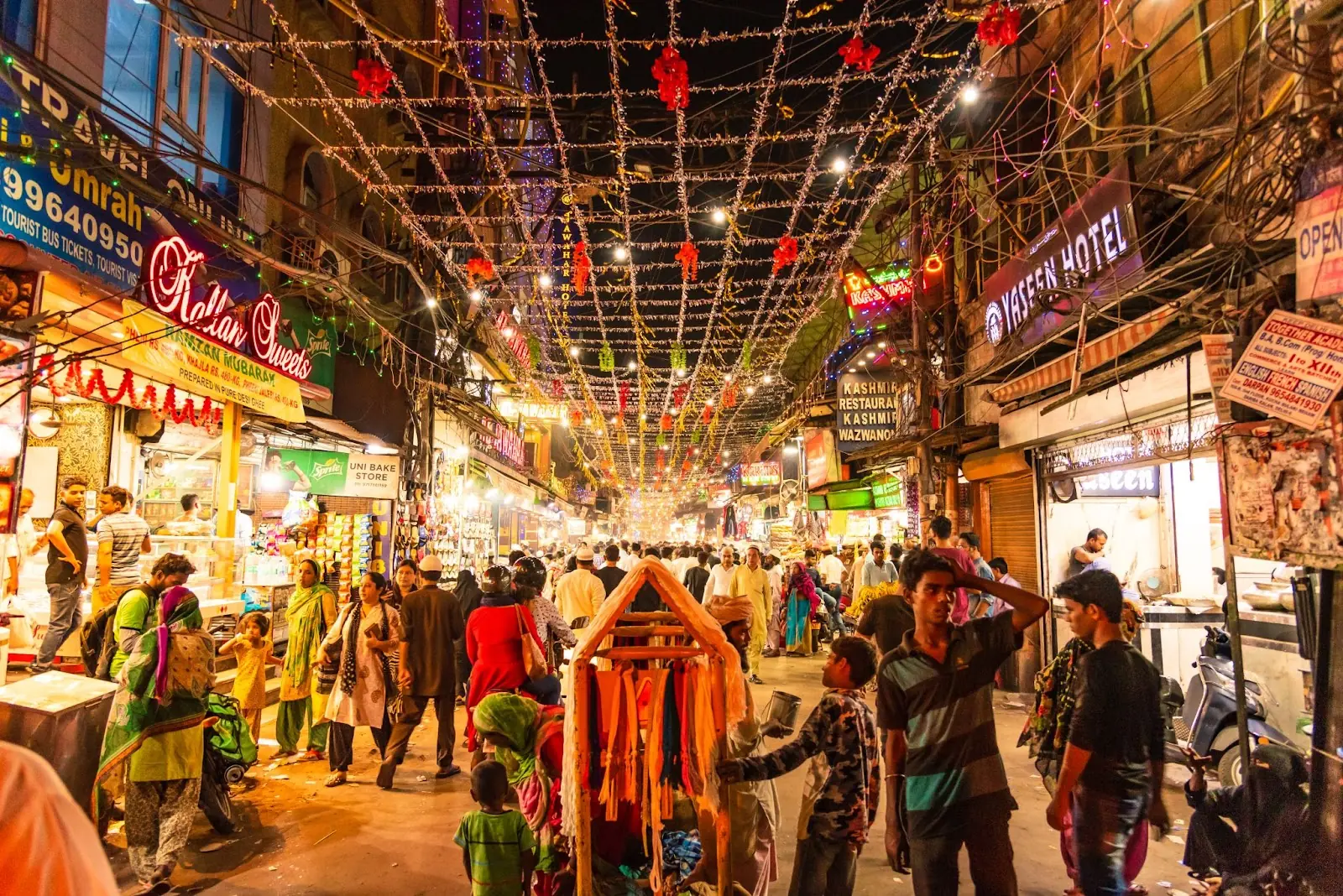People in Urdu Bazar or market street of historical part of Chandni Chowk locality of Old Delhi in the evening.