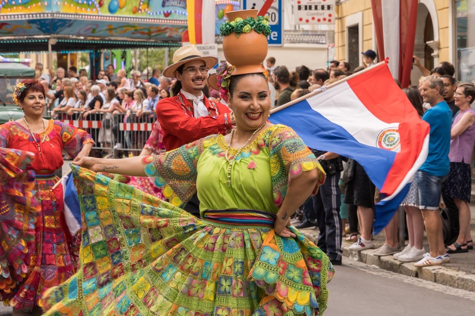 local lady dancing and a flag waving in the background