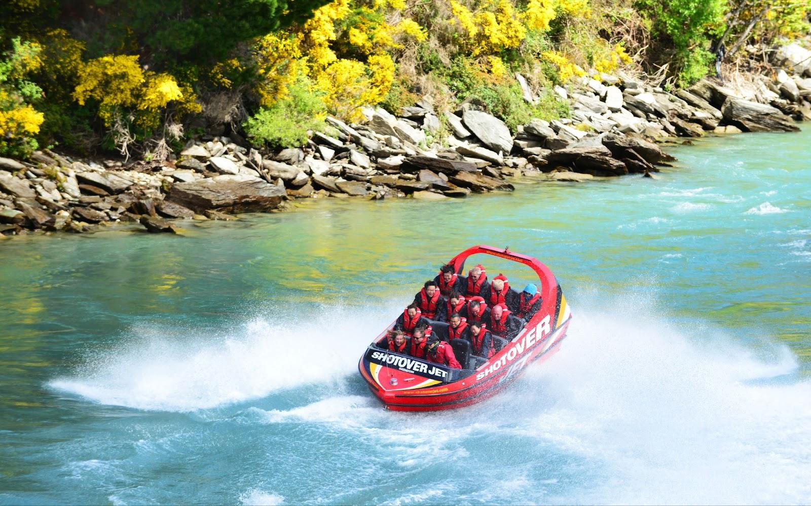 Tourists enjoy a high-speed boat ride on Queenstown's Shotover river
