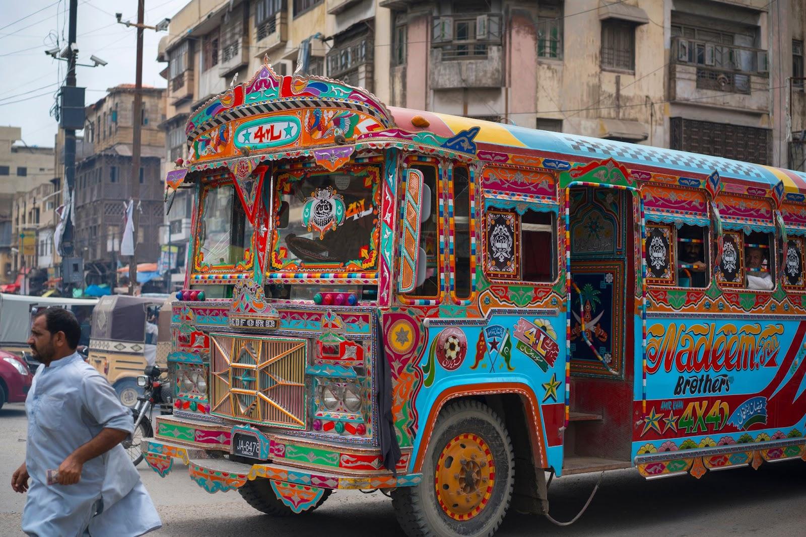 colorful painted cars are traveling at the streets of Karachi, Pakistan