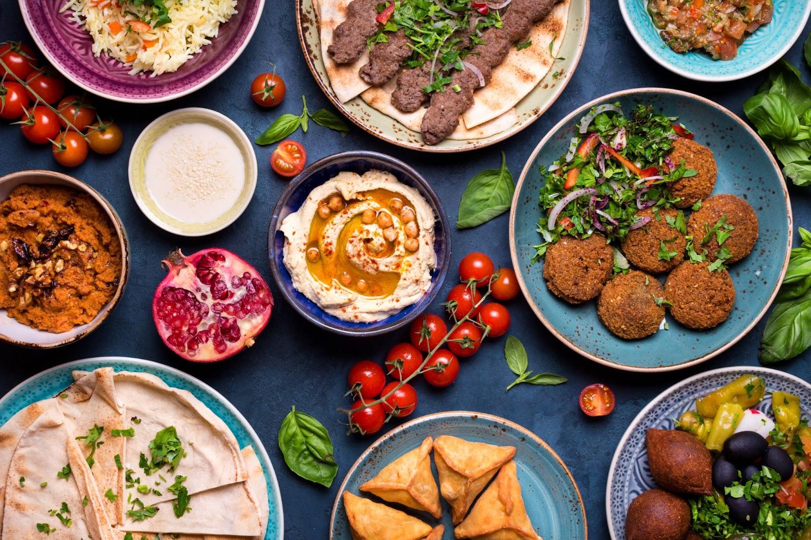 Meat kebab, falafel, baba ghanoush, muhammara, hummus, sambusak, rice, tahini, kibbeh, pita. Halal food. Lebanese cuisine