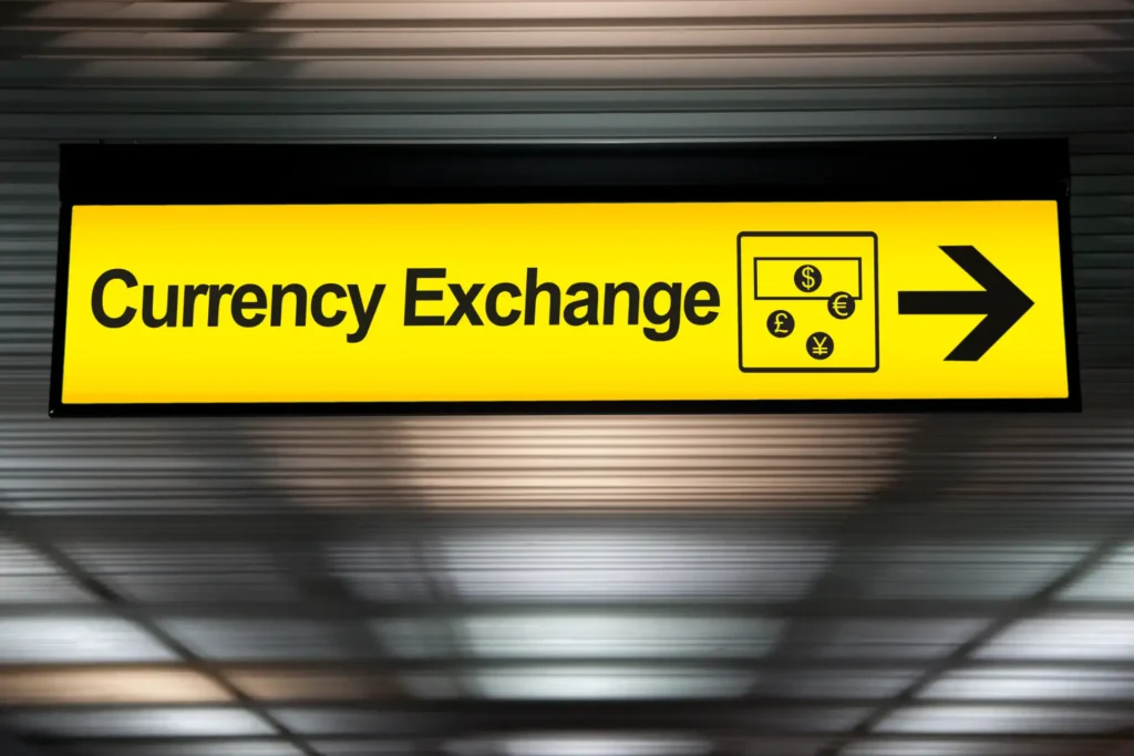 yellow currency exchange airport sign