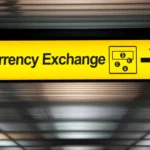 yellow currency exchange airport sign