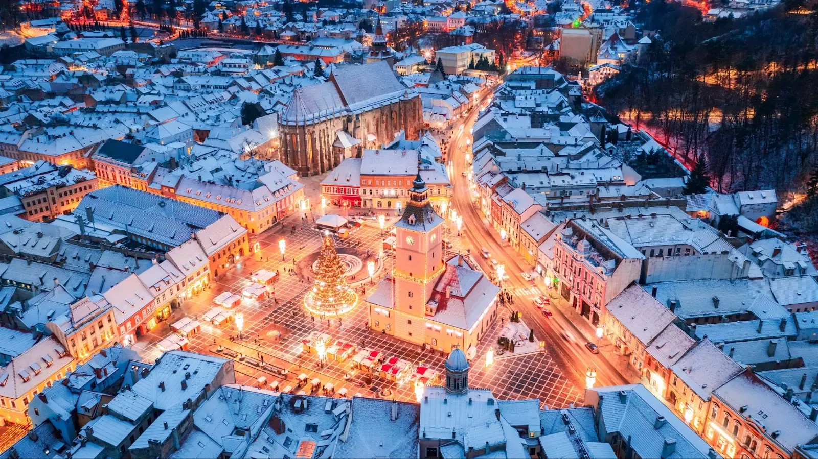 Brasov, Romania. aerial view with snowy Christmas Market and Council Square, Transylvania landmark