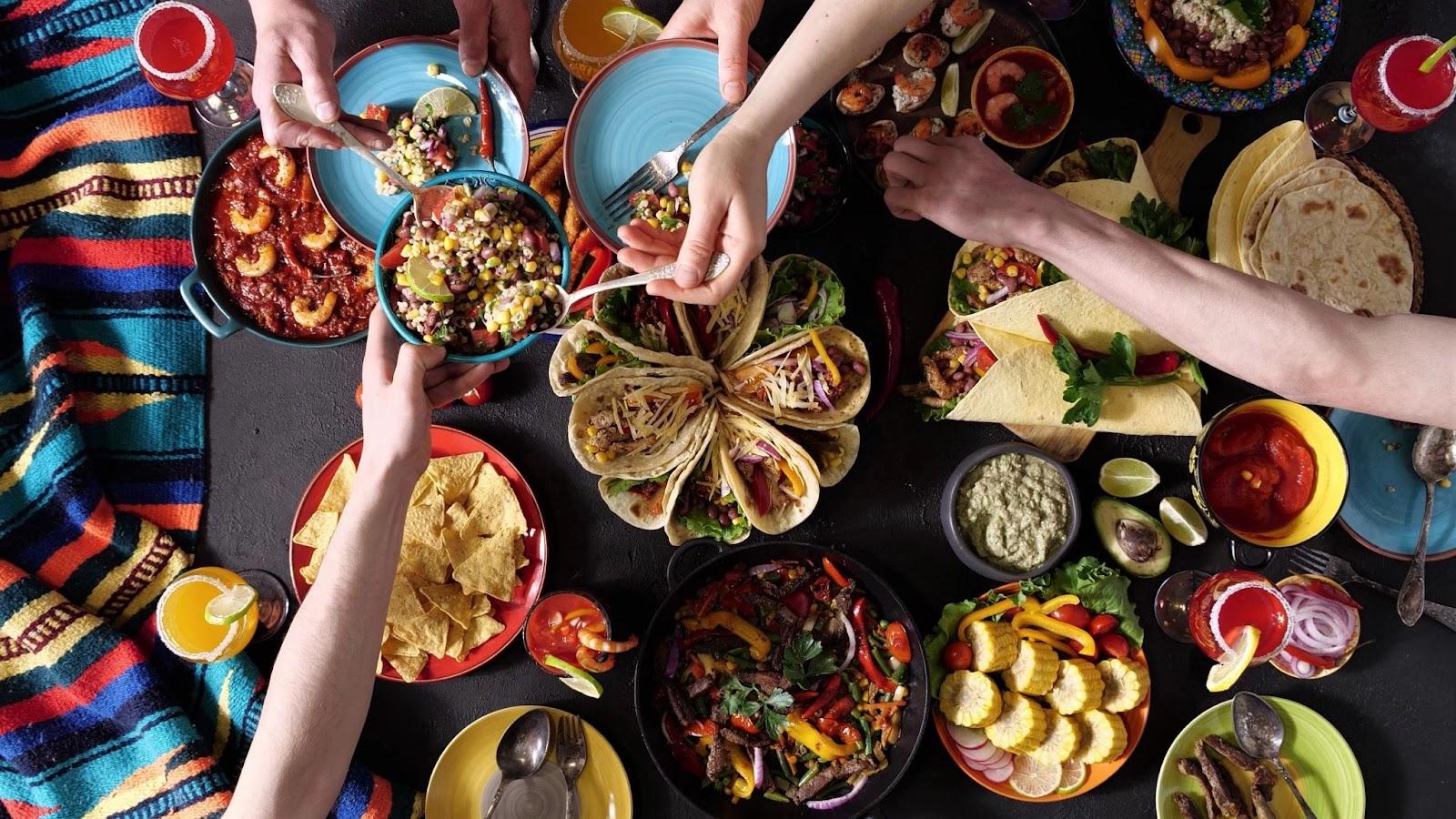 An authentic Mexican family celebrates Cinco de mayo together at a festive table