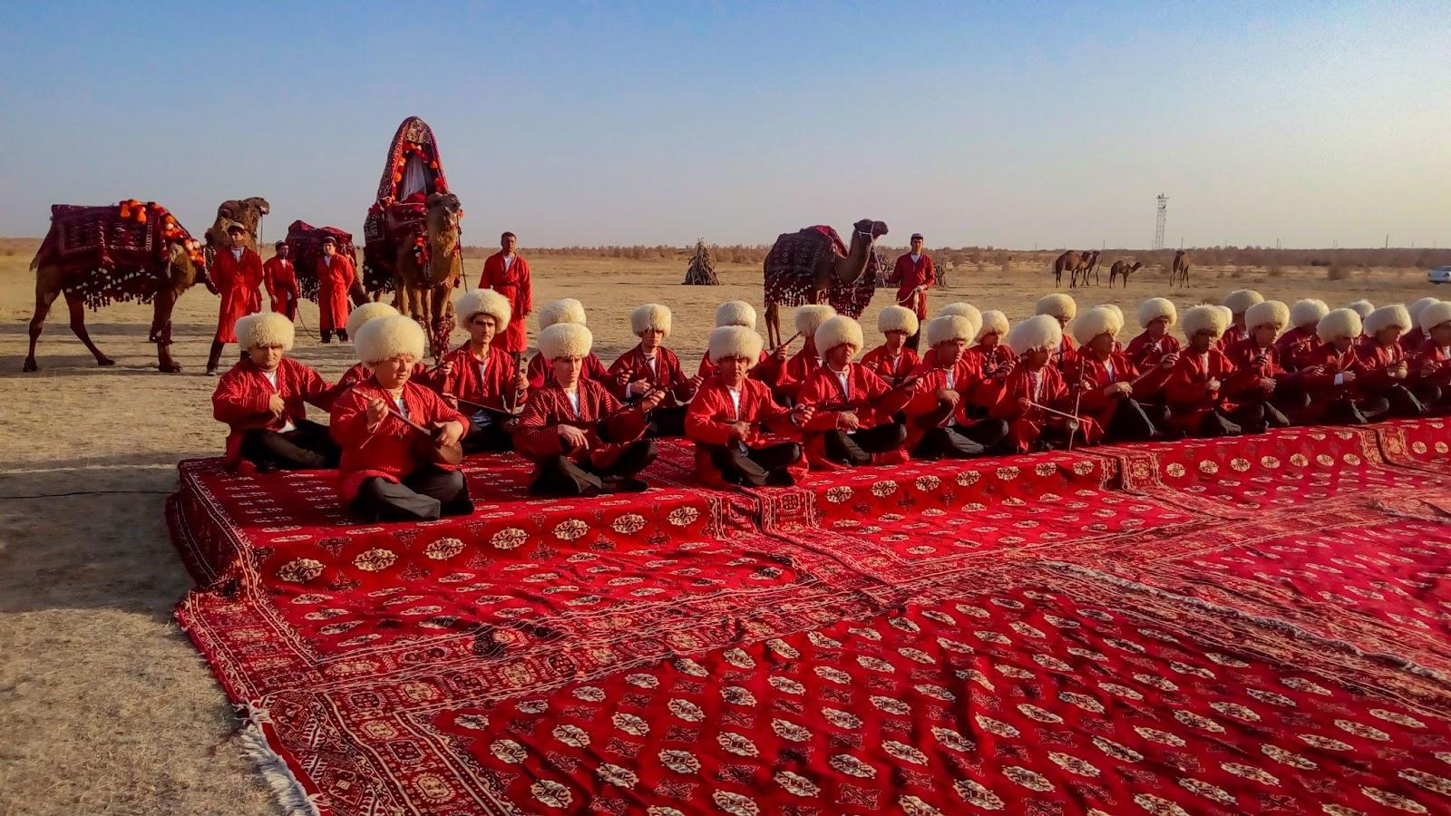 Turkmenistan men sitting on the carpet playing national musical instruments