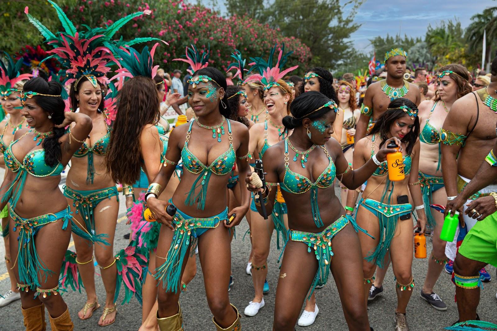 Seven Mile Beach, Grand Cayman, Cayman Islands, Caribbean. Masqueraders enjoy themselves in the Batabano Cayman Carnival.