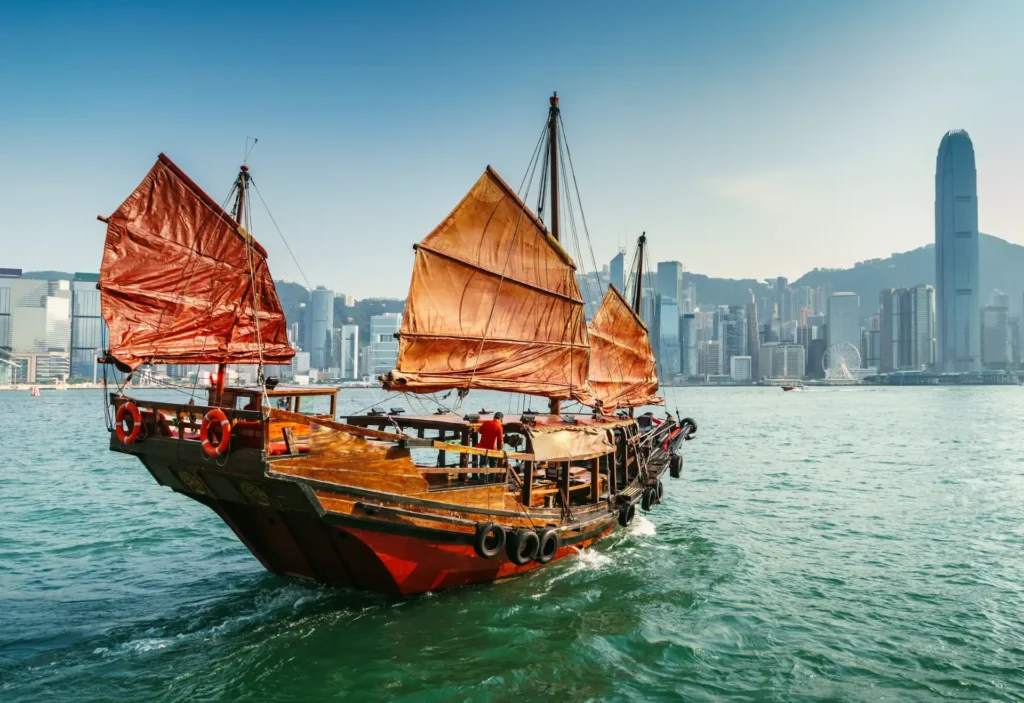 Panoramic view of the skyscrapers of Hong Kong and the sail of a roller boat. Iconic Hong Kong landmark