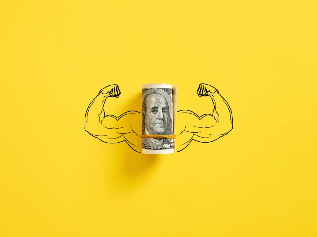 Roll of Dollars on illustrated biceps to represent the strongest currency