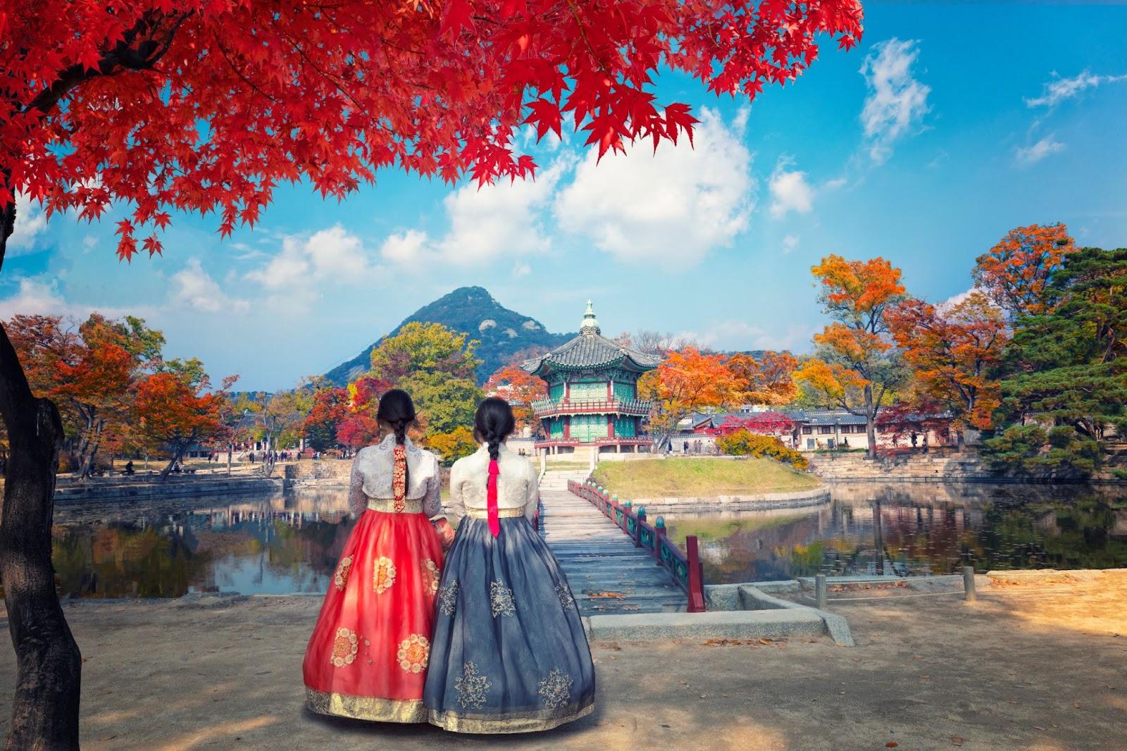 Autumn in Gyeongbokgung Palace and Korean national dress in Seoul, South Korea.