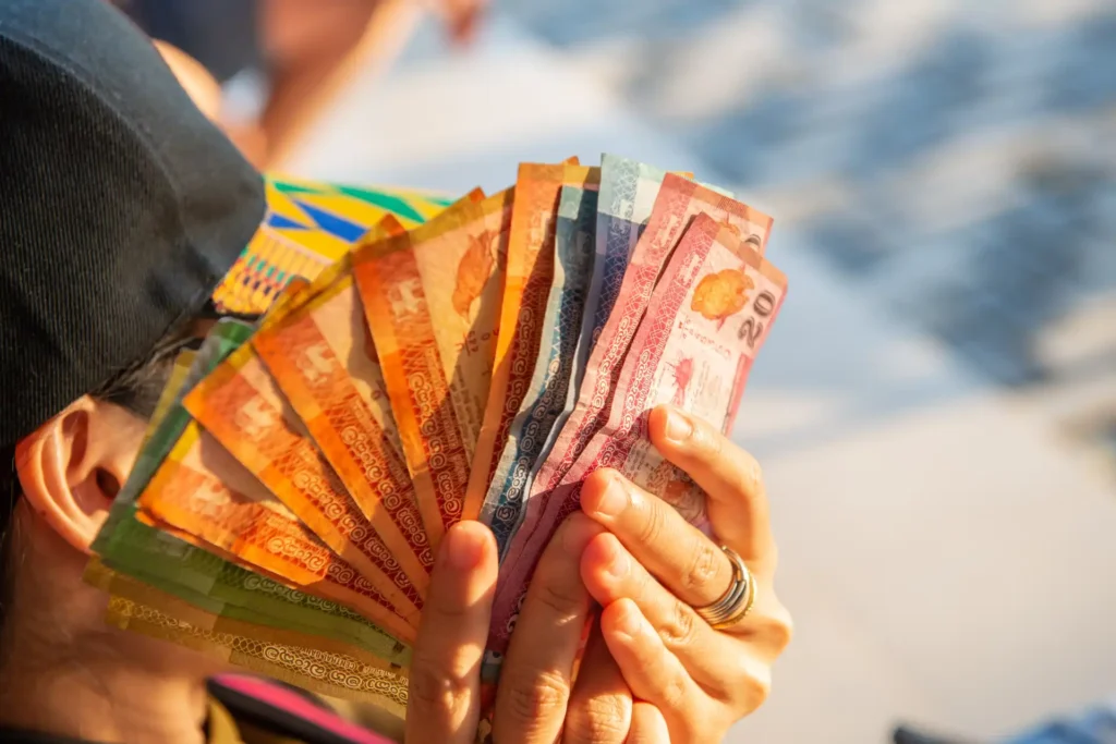 woman hand holding a group of Sri Lanka banknotes in her hand. Sri Lankan rupee is the currency of Sri Lanka